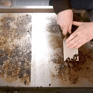using a scraper to clean your plancha